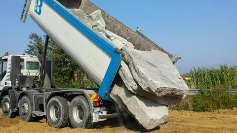 Dump Truck Unloading Rocks