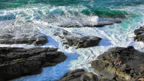 Ocean waves crashing rocks